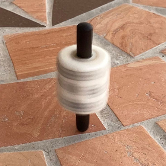 Spinning top die
